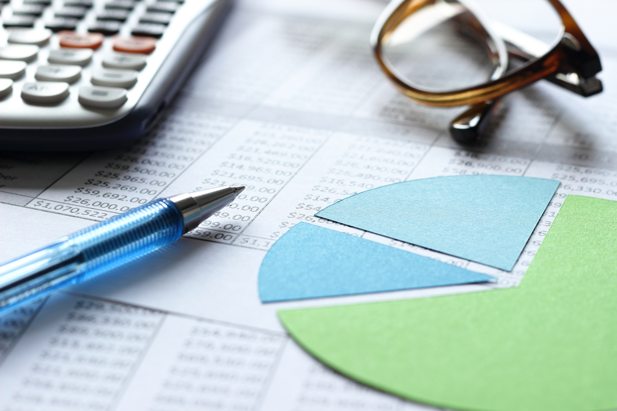 A calculator, pencil, glasses, and a chart.