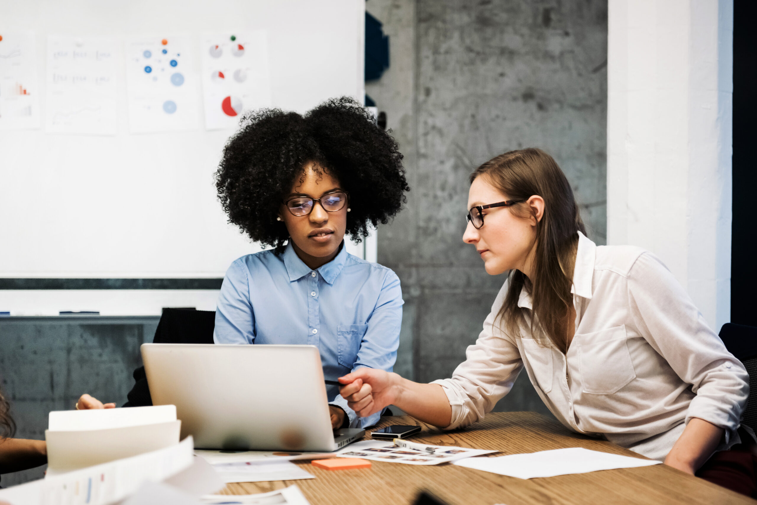 Two young women having a discussion in a business